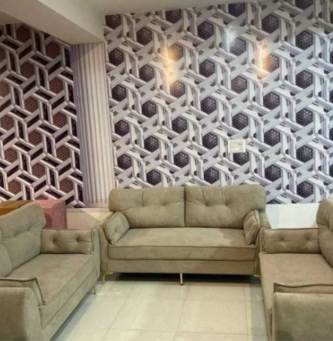 Modern living room with beige sofas and geometric wall